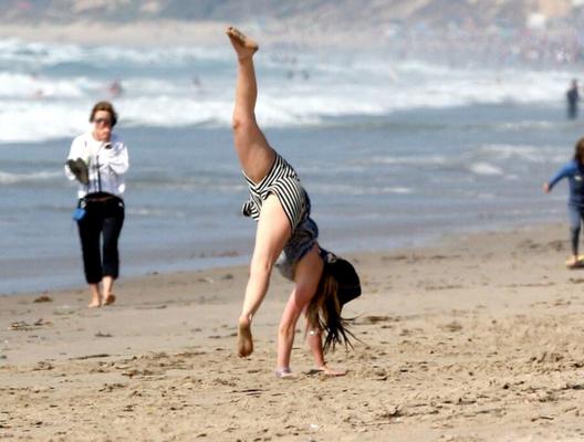 Avril Lavigne showing off at the beach