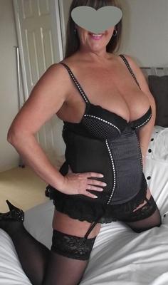 Wearing black lingerie in the bedroom