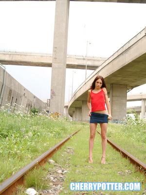 Cherry Petite getting naked on an abandoned rail road