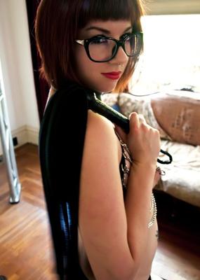 cutie in glasses flirts with bondage gear