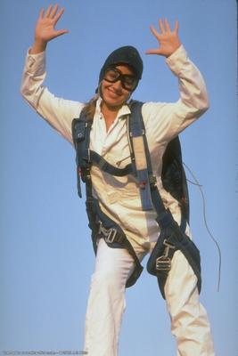 Sporty girl in sneakers after skydiving